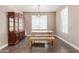 This dining room has hardwood floors, neutral paint, a wooden table and a china hutch at 16217 N 154Th Dr, Surprise, AZ 85374