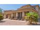 Two-story home with tan stucco, covered parking, desert landscaping, and tile roof at 16217 N 154Th Dr, Surprise, AZ 85374