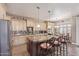Spacious eat-in kitchen with granite counters, stainless appliances, bar seating, and custom cabinets at 16217 N 154Th Dr, Surprise, AZ 85374