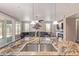 Open eat-in kitchen with granite counters, stainless appliances, undermount sink, and bar seating at 16217 N 154Th Dr, Surprise, AZ 85374