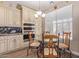 Eat-in kitchen features granite counters, stainless appliances, tile floor, and custom cabinets at 16217 N 154Th Dr, Surprise, AZ 85374
