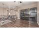 Upstairs living area with hardwood floors, custom built-ins, and iron railing at 16217 N 154Th Dr, Surprise, AZ 85374