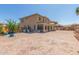 View of the home's rear exterior, featuring a large paver patio and a sunroom at 16217 N 154Th Dr, Surprise, AZ 85374