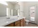 Bathroom features double sinks, wood cabinets, and access to the backyard at 16783 W Taylor St, Goodyear, AZ 85338