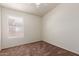 Bedroom with neutral carpeting, a window with blinds, and a ceiling fan at 16783 W Taylor St, Goodyear, AZ 85338