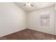 Bedroom with neutral carpeting, a window with blinds, and a ceiling fan at 16783 W Taylor St, Goodyear, AZ 85338