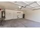 Spacious garage with concrete floors, utility sink, and overhead door at 16783 W Taylor St, Goodyear, AZ 85338