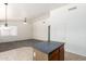 Kitchen island with eat-in dining space leads to the living area, connecting spaces with tile and carpet flooring at 16783 W Taylor St, Goodyear, AZ 85338