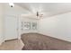 Inviting living room with neutral walls, ceiling fan, and large windows for ample natural light at 16783 W Taylor St, Goodyear, AZ 85338