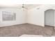 Bright living room with neutral walls, carpet flooring, and natural lighting at 16783 W Taylor St, Goodyear, AZ 85338