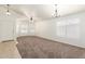 Spacious living room with neutral paint, carpet flooring, and bright lighting at 16783 W Taylor St, Goodyear, AZ 85338