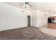 Large living room with neutral walls, carpet flooring, and easy access to the kitchen at 16783 W Taylor St, Goodyear, AZ 85338