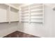 Large walk-in closet with built-in shelving and metal rods at 16783 W Taylor St, Goodyear, AZ 85338