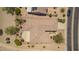 Striking aerial view of the home's roof showing lush backyard landscaping and covered patio at 17359 W Calistoga Dr, Surprise, AZ 85387