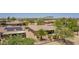 Wide shot shows desert community with homes that have tile roofs, desert landscaping, and palm trees at 17359 W Calistoga Dr, Surprise, AZ 85387