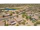 Attractive aerial shot of a desert community featuring a neighborhood pond and lush landscaping at 17359 W Calistoga Dr, Surprise, AZ 85387