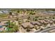 Wide aerial view features single-story desert home near golf course and community amenities at 17359 W Calistoga Dr, Surprise, AZ 85387