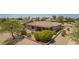 Beautiful backyard exterior with covered patio, desert landscaping, and manicured garden at 17359 W Calistoga Dr, Surprise, AZ 85387