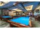 Well-lit billiard room with multiple tables, providing ample space for recreation and friendly competition at 17359 W Calistoga Dr, Surprise, AZ 85387