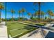 Active bocce ball court with lush green turf and palm trees at 17359 W Calistoga Dr, Surprise, AZ 85387