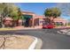 Front exterior of community building with mature landscaping and parking at 17359 W Calistoga Dr, Surprise, AZ 85387