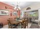 Elegant dining room with a stylish chandelier, comfortable seating, and sliding door leading to outdoor area at 17359 W Calistoga Dr, Surprise, AZ 85387