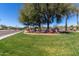 Community entrance with lush greenery, colorful flowers, and clear signage for easy identification at 17359 W Calistoga Dr, Surprise, AZ 85387