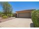 Inviting front exterior with lush desert landscaping and concrete driveway leading to a two-car garage at 17359 W Calistoga Dr, Surprise, AZ 85387