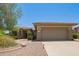 Welcoming front exterior featuring a desert landscaped yard and two-car garage at 17359 W Calistoga Dr, Surprise, AZ 85387