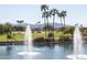 Picturesque golf course with a water feature and fountains surrounded by palm trees and landscaping at 17359 W Calistoga Dr, Surprise, AZ 85387