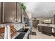 Modern kitchen featuring granite countertops, stainless steel appliances, and a seamless view into the dining area at 17359 W Calistoga Dr, Surprise, AZ 85387