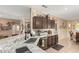 Charming kitchen showcasing granite counters and dark cabinetry with views to the dining room at 17359 W Calistoga Dr, Surprise, AZ 85387