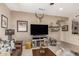 Cozy living room with stylish decor, a large TV, and comfortable seating arrangement at 17359 W Calistoga Dr, Surprise, AZ 85387