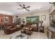 Inviting living room featuring comfortable leather seating, a ceiling fan, and ample natural light at 17359 W Calistoga Dr, Surprise, AZ 85387