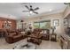 Spacious living room with comfortable leather furniture, a ceiling fan, and a cozy atmosphere at 17359 W Calistoga Dr, Surprise, AZ 85387