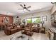 Inviting living room featuring leather sofas, ceiling fan, tile floors, and stylish decor creating a comfortable ambiance at 17359 W Calistoga Dr, Surprise, AZ 85387
