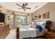 Cozy main bedroom featuring a ceiling fan, bright windows, and decorative western accents at 17359 W Calistoga Dr, Surprise, AZ 85387