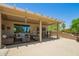 Comfortable covered patio featuring wicker furniture and a dining area at 17359 W Calistoga Dr, Surprise, AZ 85387