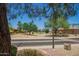 Charming street view featuring well-maintained landscaping and a glimpse of neighboring homes and palm trees at 17359 W Calistoga Dr, Surprise, AZ 85387