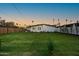 Spacious backyard with lush green grass, wood fence, and ample room for outdoor activities at 1818 W Highland Ave, Phoenix, AZ 85015