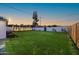 Expansive backyard with a lush lawn, tall privacy fence, and ample space for outdoor enjoyment at 1818 W Highland Ave, Phoenix, AZ 85015