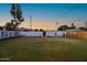 Large, private backyard with a well-maintained lawn and mature trees at 1818 W Highland Ave, Phoenix, AZ 85015