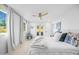 Bright bedroom featuring hardwood floors, french doors to the backyard, and modern ceiling fan at 1818 W Highland Ave, Phoenix, AZ 85015