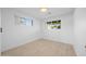 A simple, bright bedroom with hardwood floors and large windows at 1818 W Highland Ave, Phoenix, AZ 85015