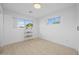 A simple, bright bedroom with hardwood floors and large windows at 1818 W Highland Ave, Phoenix, AZ 85015