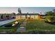 Inviting home with manicured lawn, pathway lights, and mature landscaping at 1818 W Highland Ave, Phoenix, AZ 85015