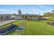 Single-story home showcasing a well-kept lawn, concrete driveway, and illuminated pathway at 1818 W Highland Ave, Phoenix, AZ 85015