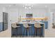 Bright kitchen features an island with bar seating, pendant lighting and updated appliances at 1818 W Highland Ave, Phoenix, AZ 85015