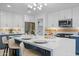 Modern kitchen featuring a large island, white cabinets, stainless steel appliances, and stylish light fixture at 1818 W Highland Ave, Phoenix, AZ 85015