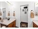 Bright bathroom features a vanity with a white countertop and sink, towel, and decorative mirror at 18455 W San Carlos Dr, Goodyear, AZ 85338